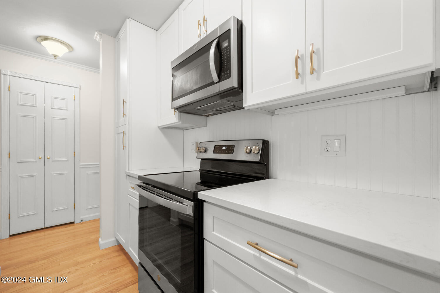 76 Maple Tree Avenue, Unit 3 Stamford, CT 06906 - Photo 14 of 33 a kitchen with stainless steel appliances granite countertop white cabinets and a stove top oven