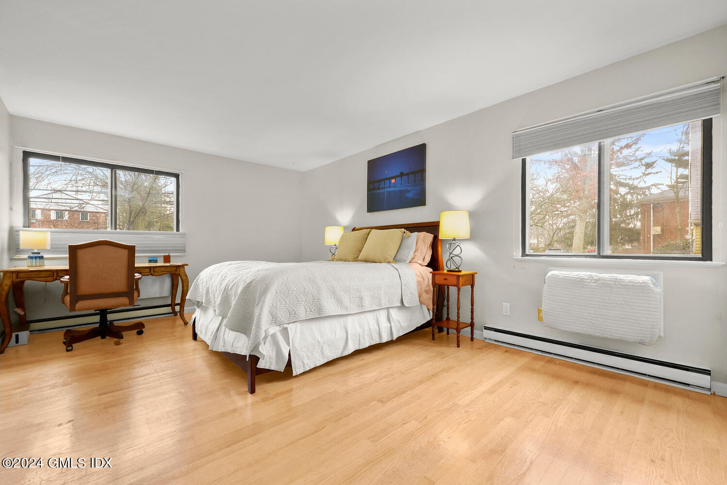 76 Maple Tree Avenue, Unit 3 Stamford, CT 06906 - Photo 19 of 33 a bedroom with a bed and wooden floor