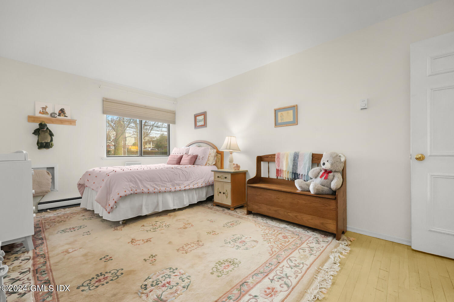 76 Maple Tree Avenue, Unit 3 Stamford, CT 06906 - Photo 23 of 33 a bedroom with a bed and wooden floor