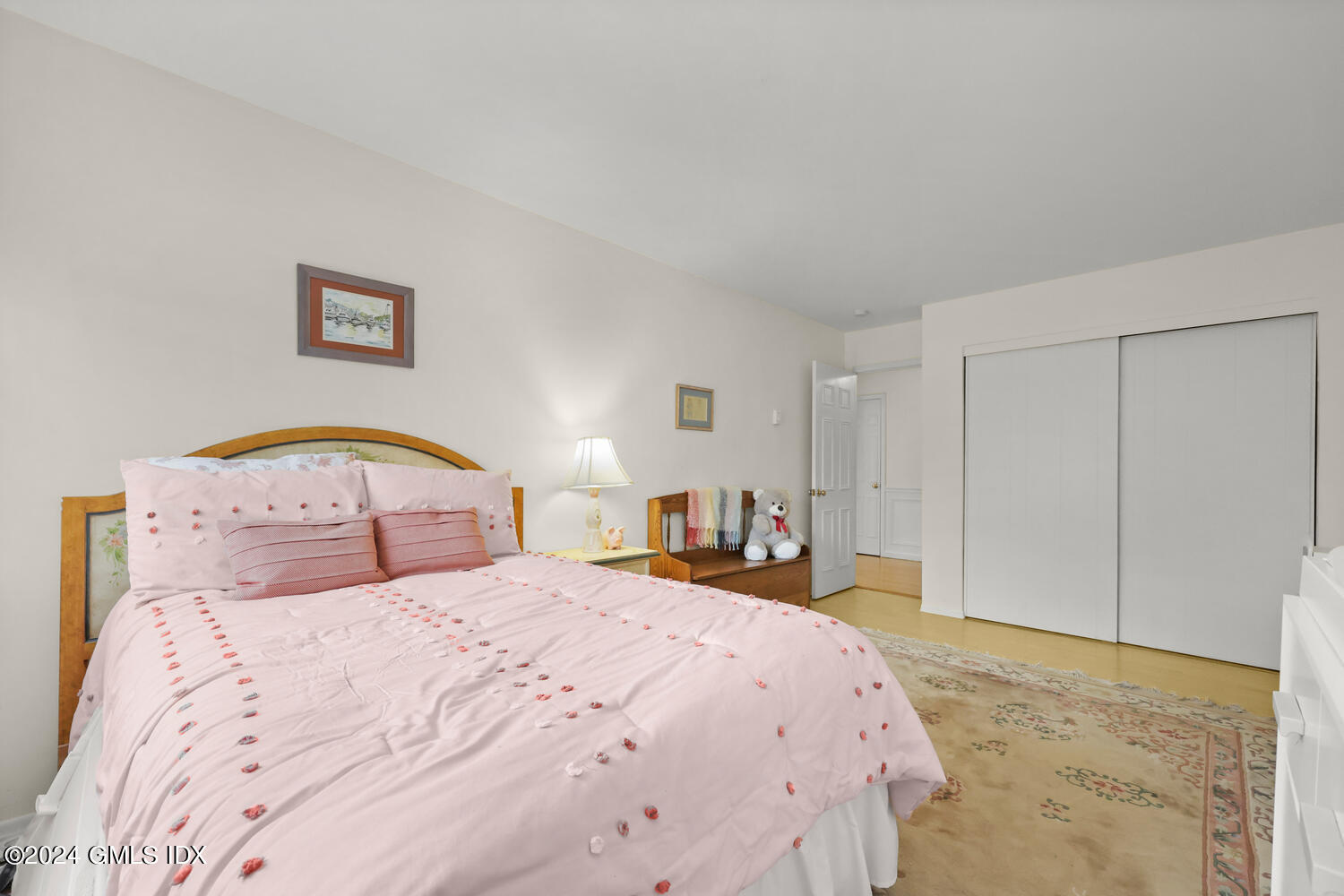 76 Maple Tree Avenue, Unit 3 Stamford, CT 06906 - Photo 25 of 33 a bedroom with a large bed and a chandelier