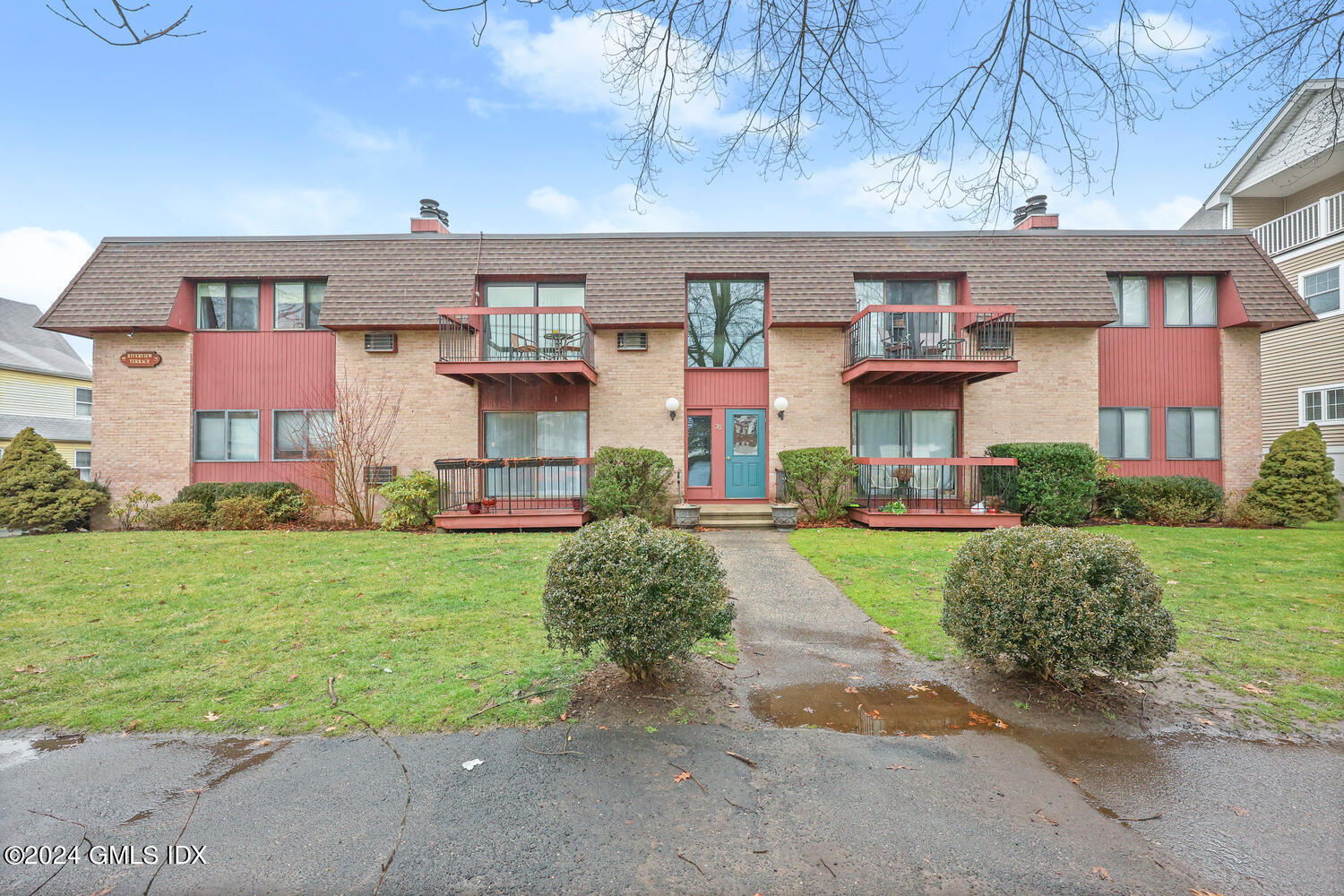 76 Maple Tree Avenue, Unit 3 Stamford, CT 06906 - Photo 26 of 33 a front view of a house with a yard and garage