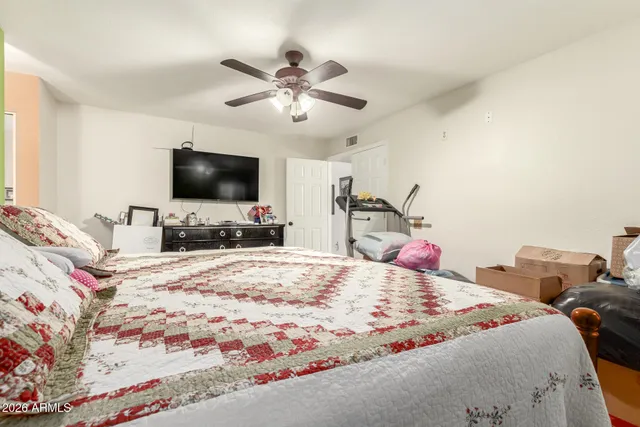 a bedroom with a bed and a flat screen tv