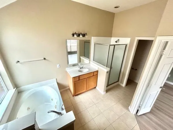 a view of kitchen with furniture and refrigerator
