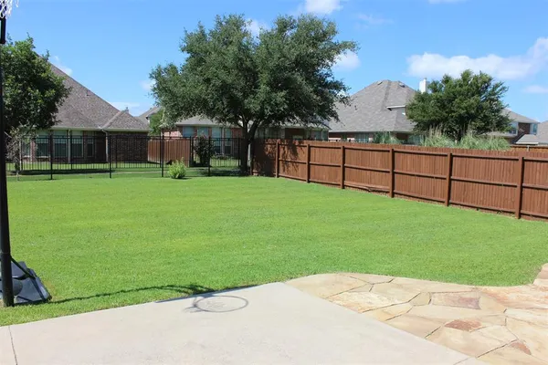 a view of a backyard with a garden and trees