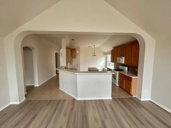 a view of kitchen with refrigerator microwave and stove