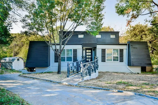 a front view of a house with garden and patio