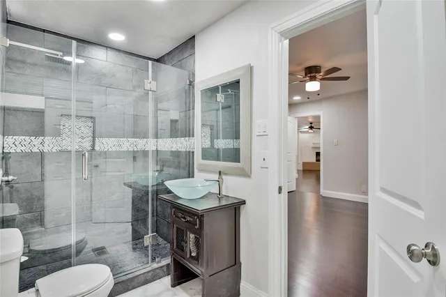 a bathroom with a sink toilet and shower