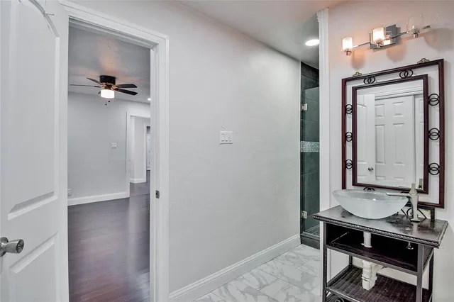 an empty room with wooden floor and windows with curtains view