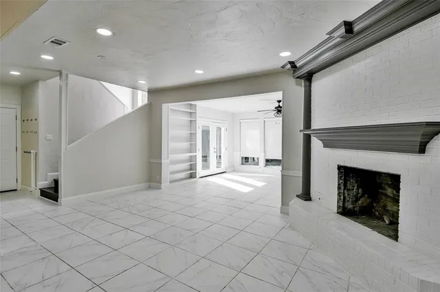 a large kitchen with a refrigerator and a stove top oven