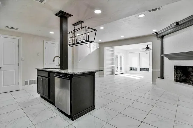 a kitchen with stainless steel appliances granite countertop a stove and a sink
