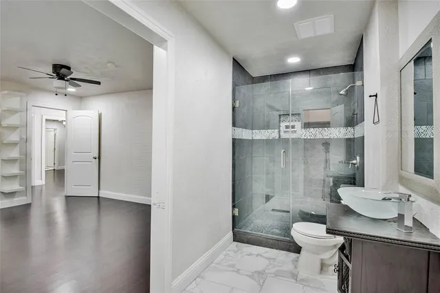 a bathroom with a sink toilet a mirror and shower