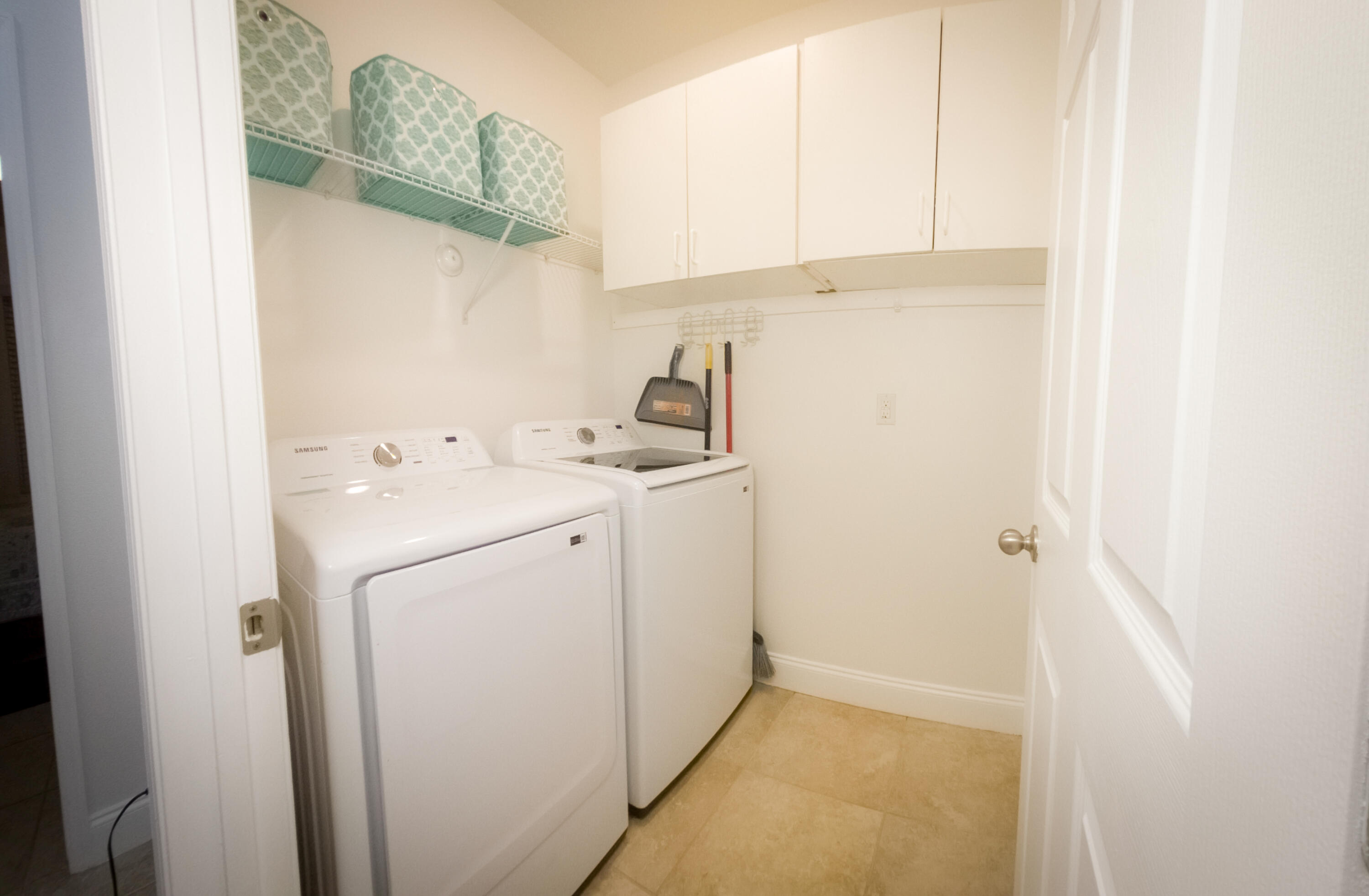 1162 Southwest Coleman Avenue Port St. Lucie, FL 34953 - Photo 12 of 27 a utility room with dryer and washer