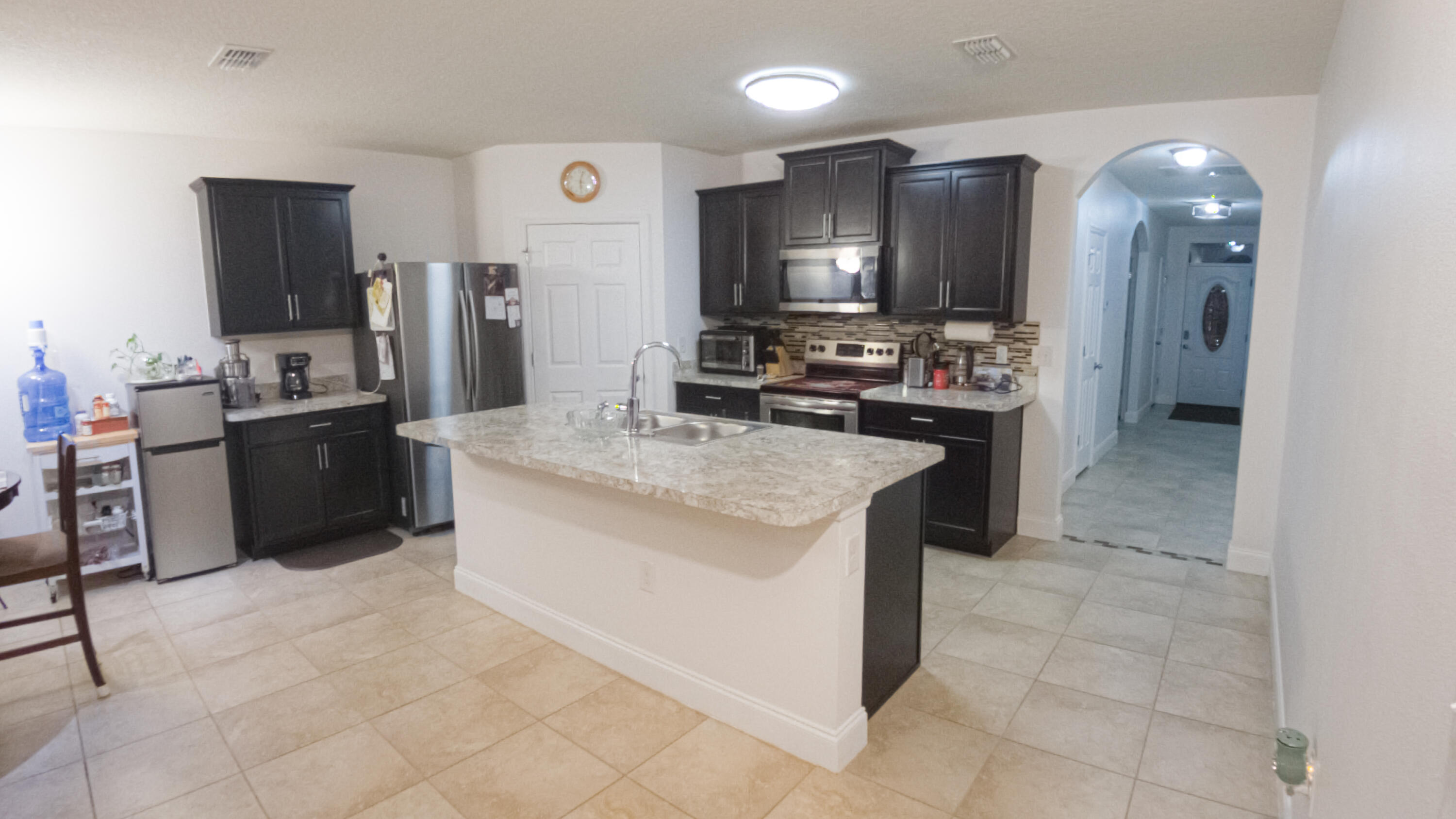 1162 Southwest Coleman Avenue Port St. Lucie, FL 34953 - Photo 13 of 27 a kitchen with stainless steel appliances granite countertop a stove oven and a refrigerator