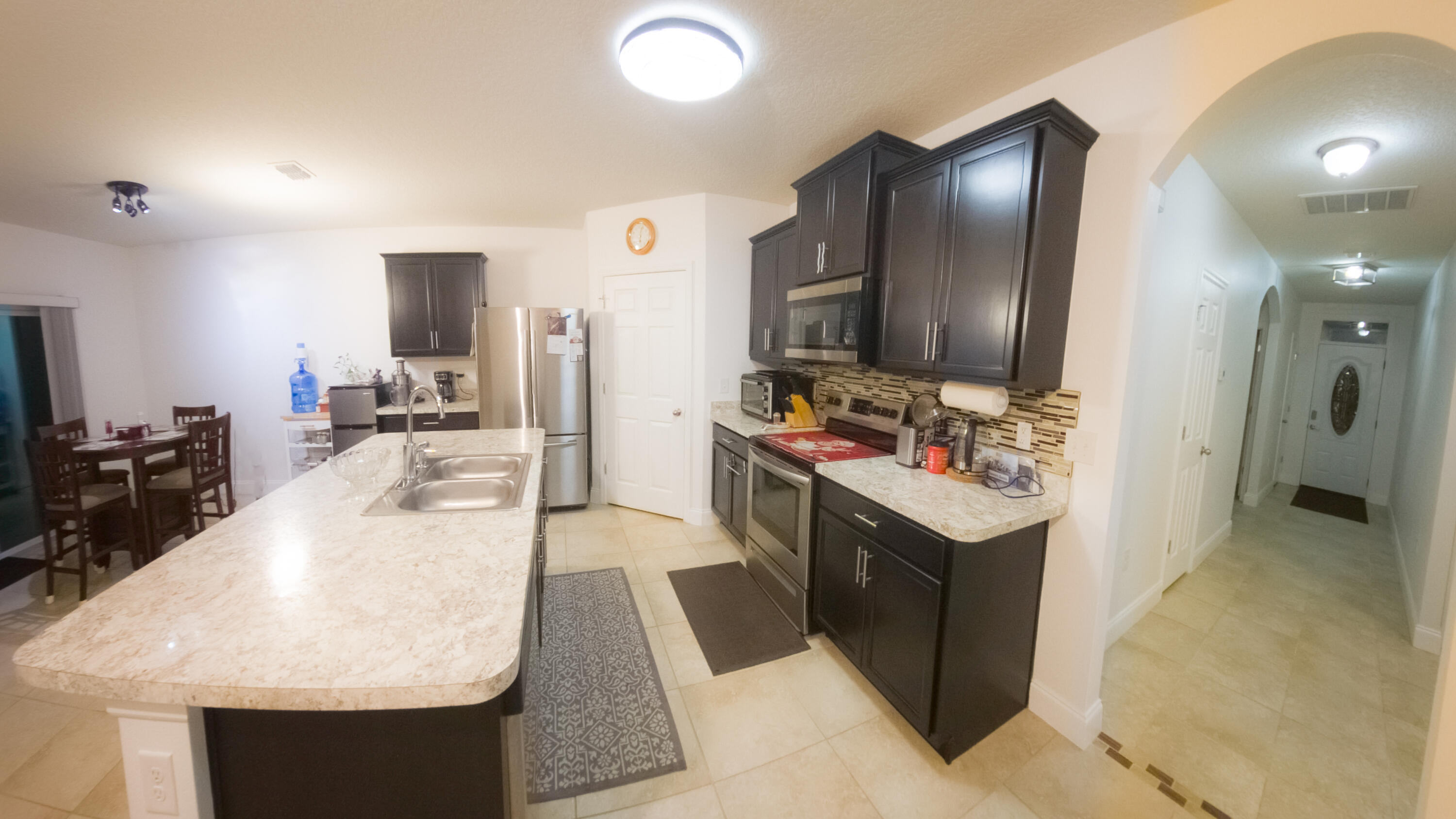 1162 Southwest Coleman Avenue Port St. Lucie, FL 34953 - Photo 14 of 27 a kitchen with stainless steel appliances granite countertop a sink stove and refrigerator