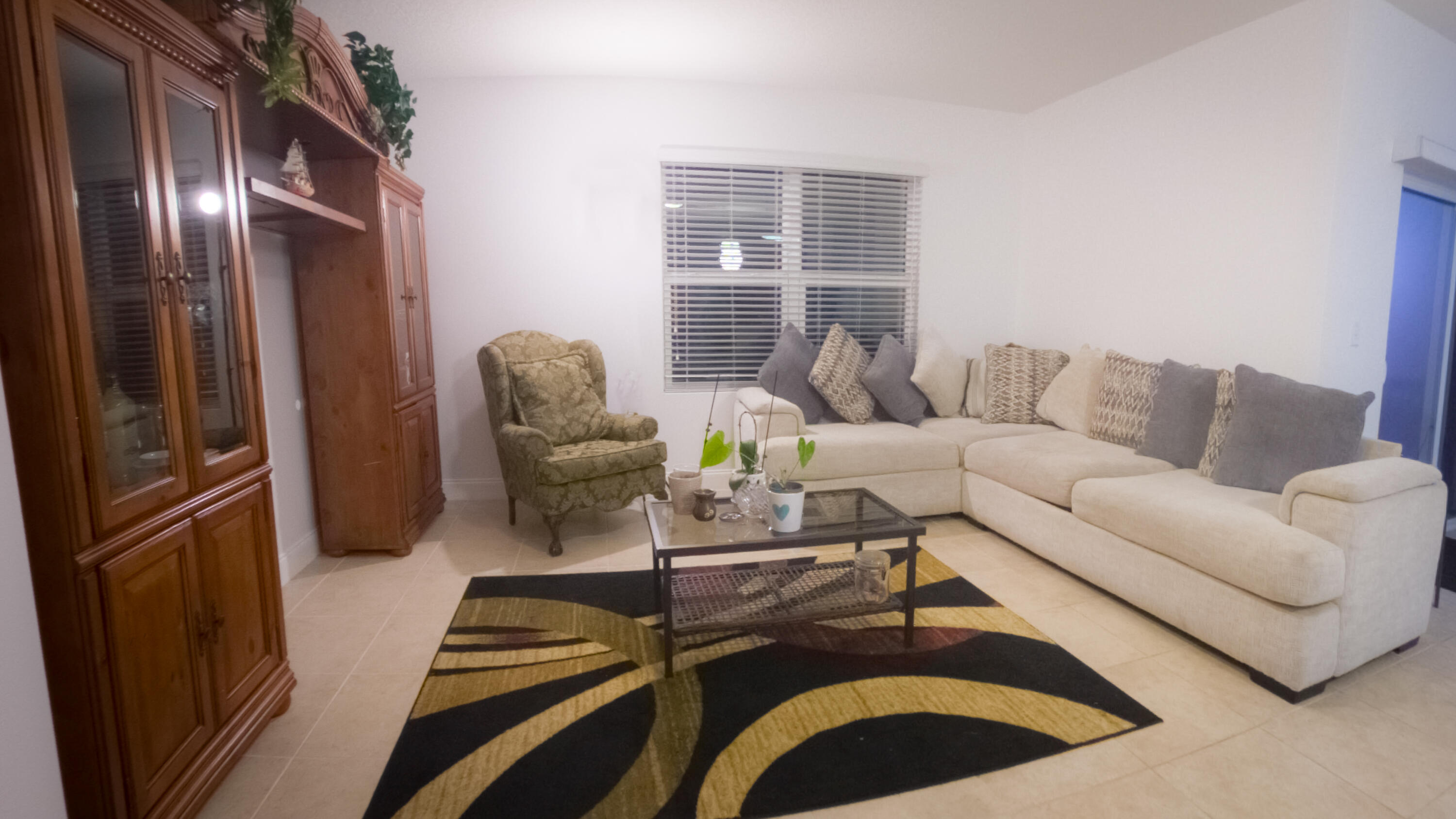 1162 Southwest Coleman Avenue Port St. Lucie, FL 34953 - Photo 17 of 27 a living room with furniture rug and a window