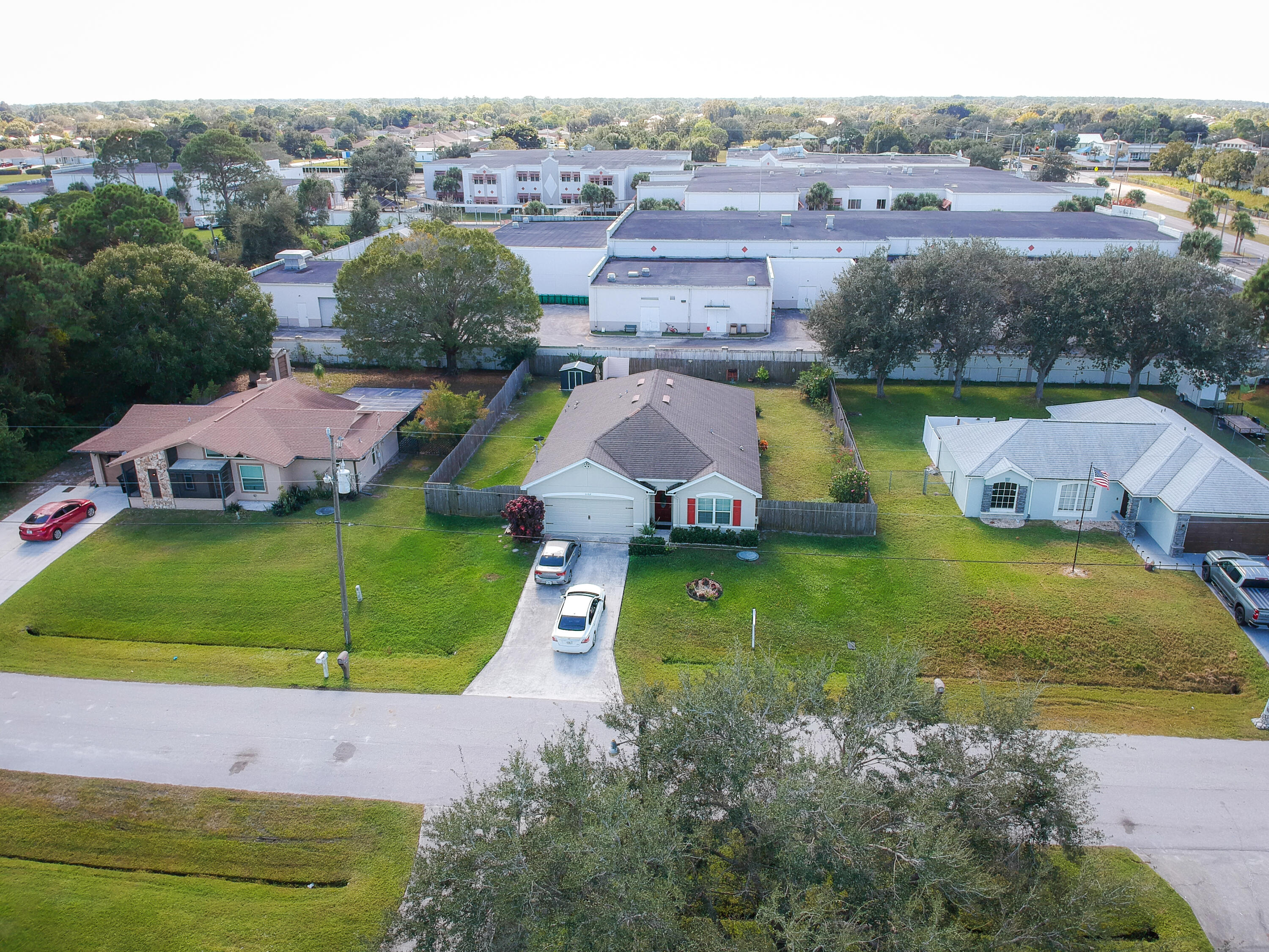 1162 Southwest Coleman Avenue Port St. Lucie, FL 34953 - Photo 2 of 27 an aerial view of a house with a swimming pool yard and mountain view in back