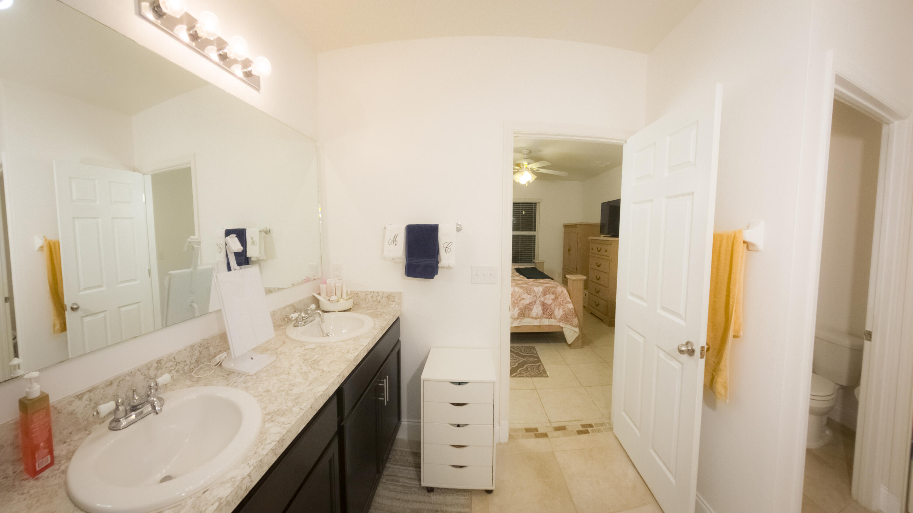 1162 Southwest Coleman Avenue Port St. Lucie, FL 34953 - Photo 21 of 27 a spacious bathroom with a granite countertop sink and a mirror