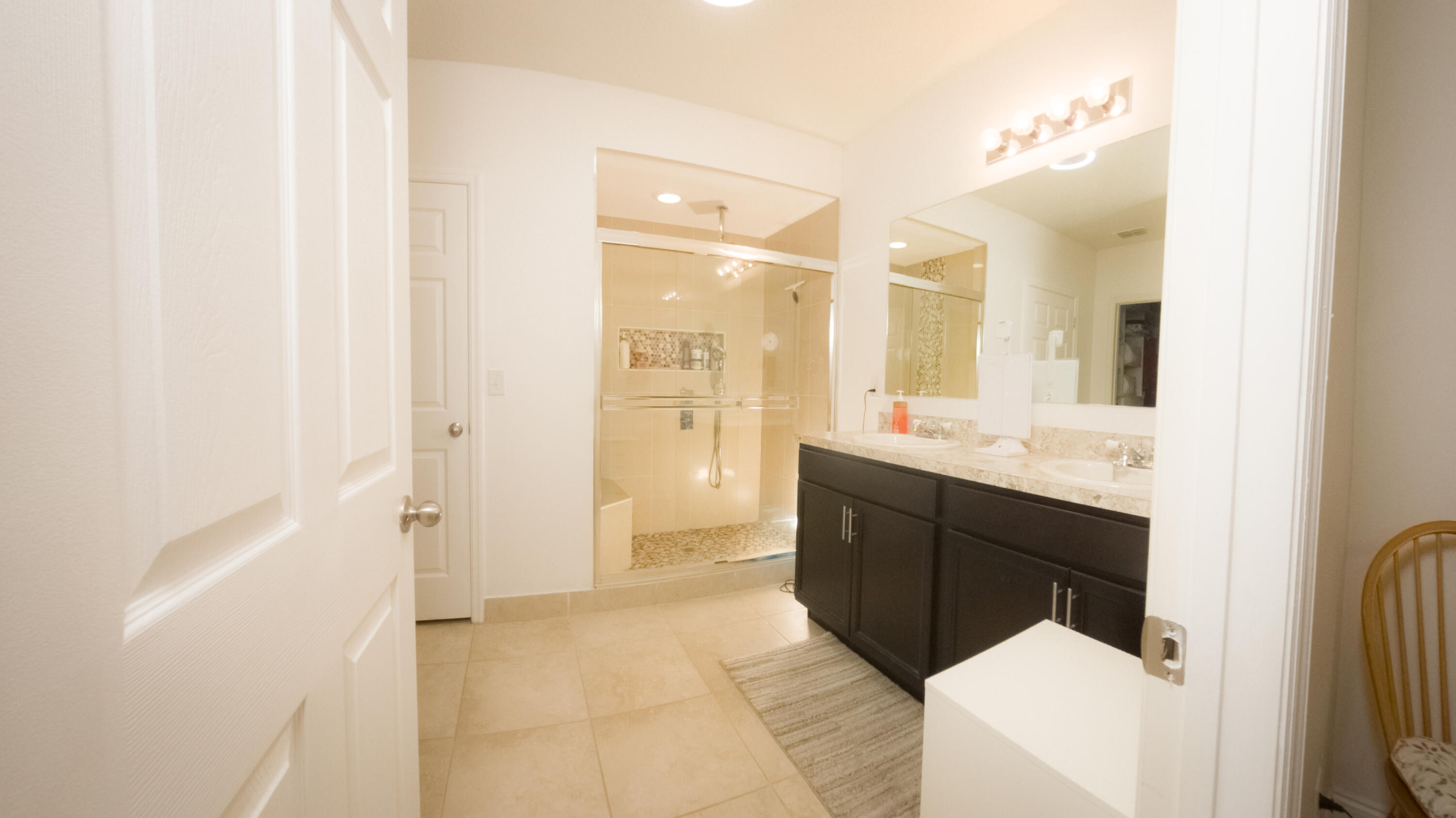 1162 Southwest Coleman Avenue Port St. Lucie, FL 34953 - Photo 22 of 27 a bathroom with a sink a toilet a mirror and shower