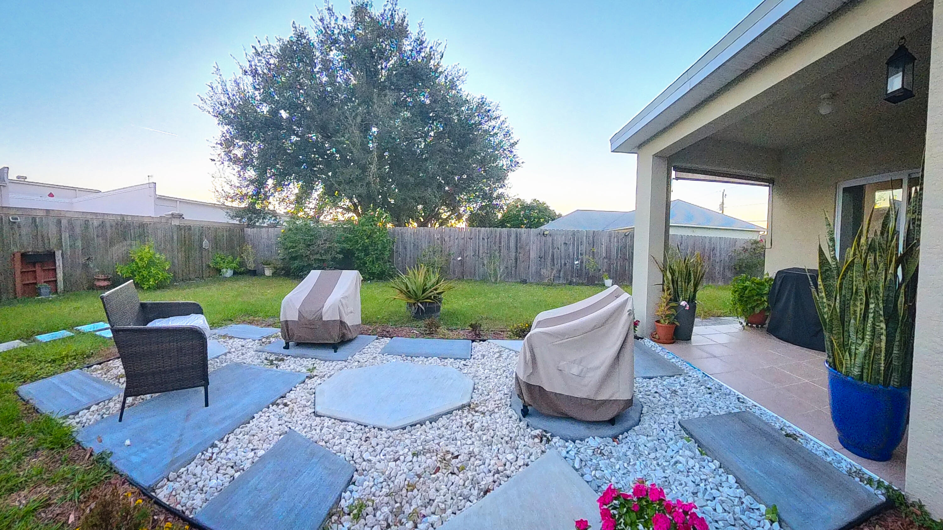 1162 Southwest Coleman Avenue Port St. Lucie, FL 34953 - Photo 24 of 27 a view of a patio with couches chairs and a fire pit