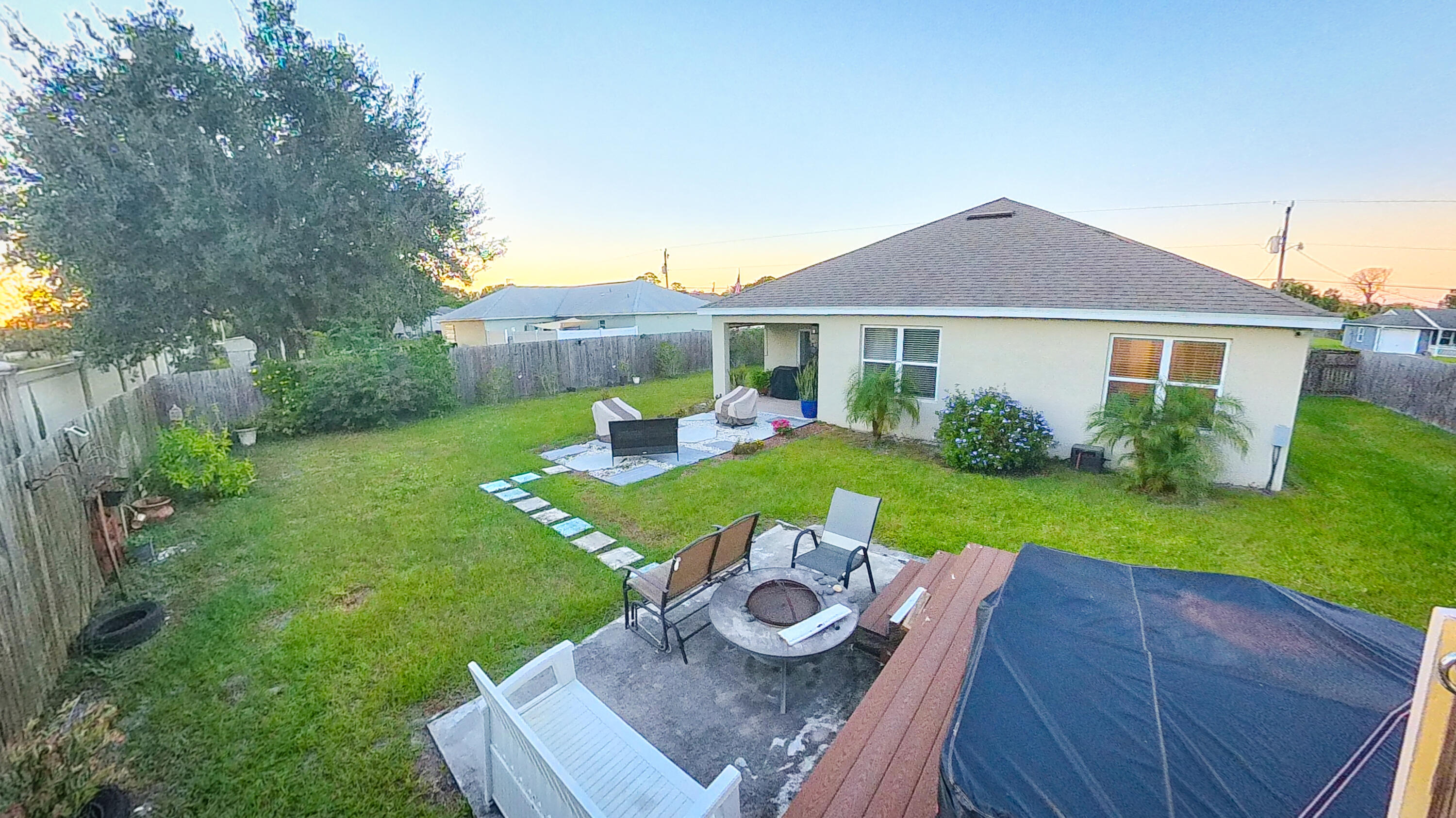1162 Southwest Coleman Avenue Port St. Lucie, FL 34953 - Photo 26 of 27 a view of a house with backyard sitting area and garden