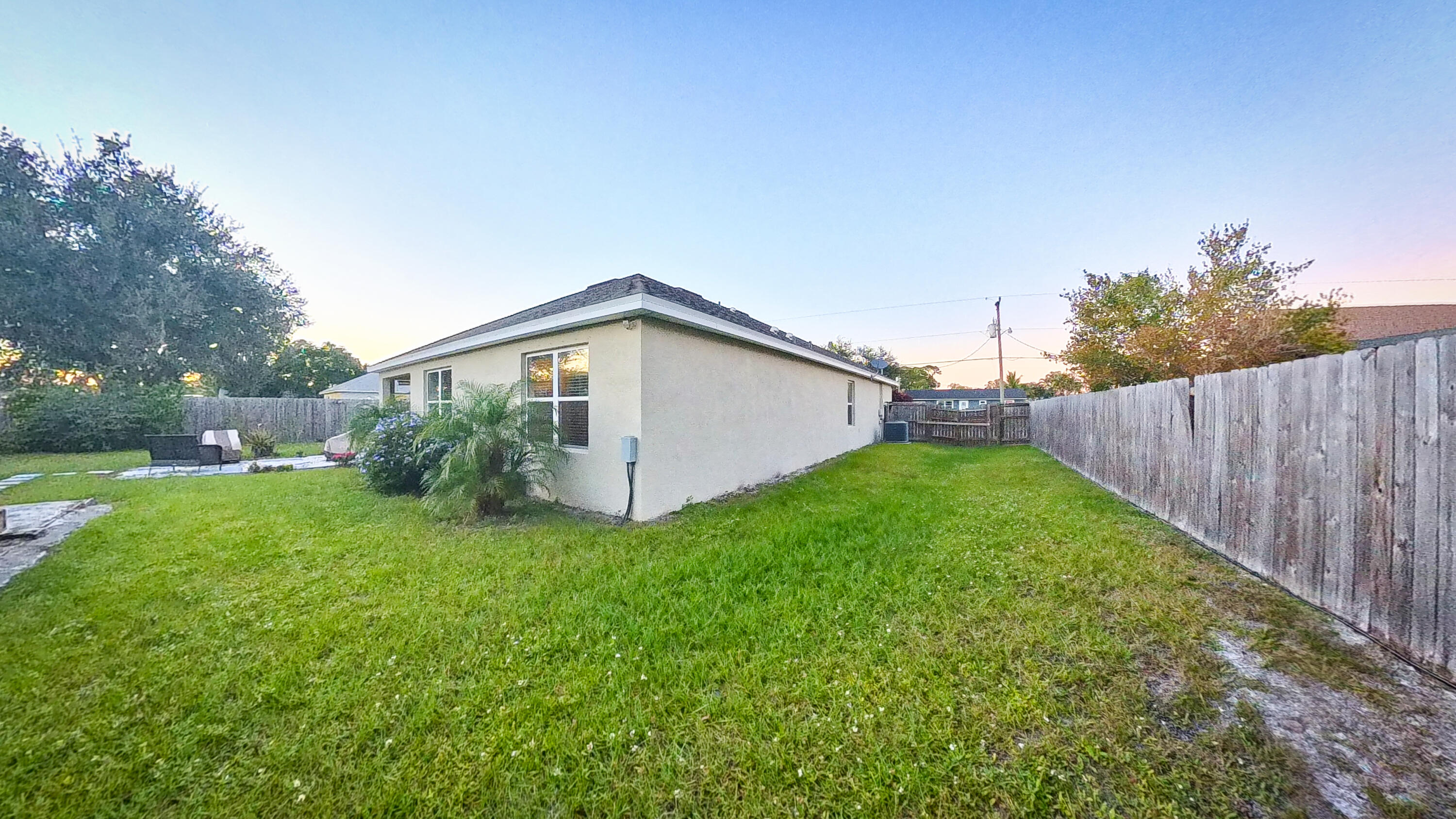 1162 Southwest Coleman Avenue Port St. Lucie, FL 34953 - Photo 27 of 27 a view of a house with backyard and garden