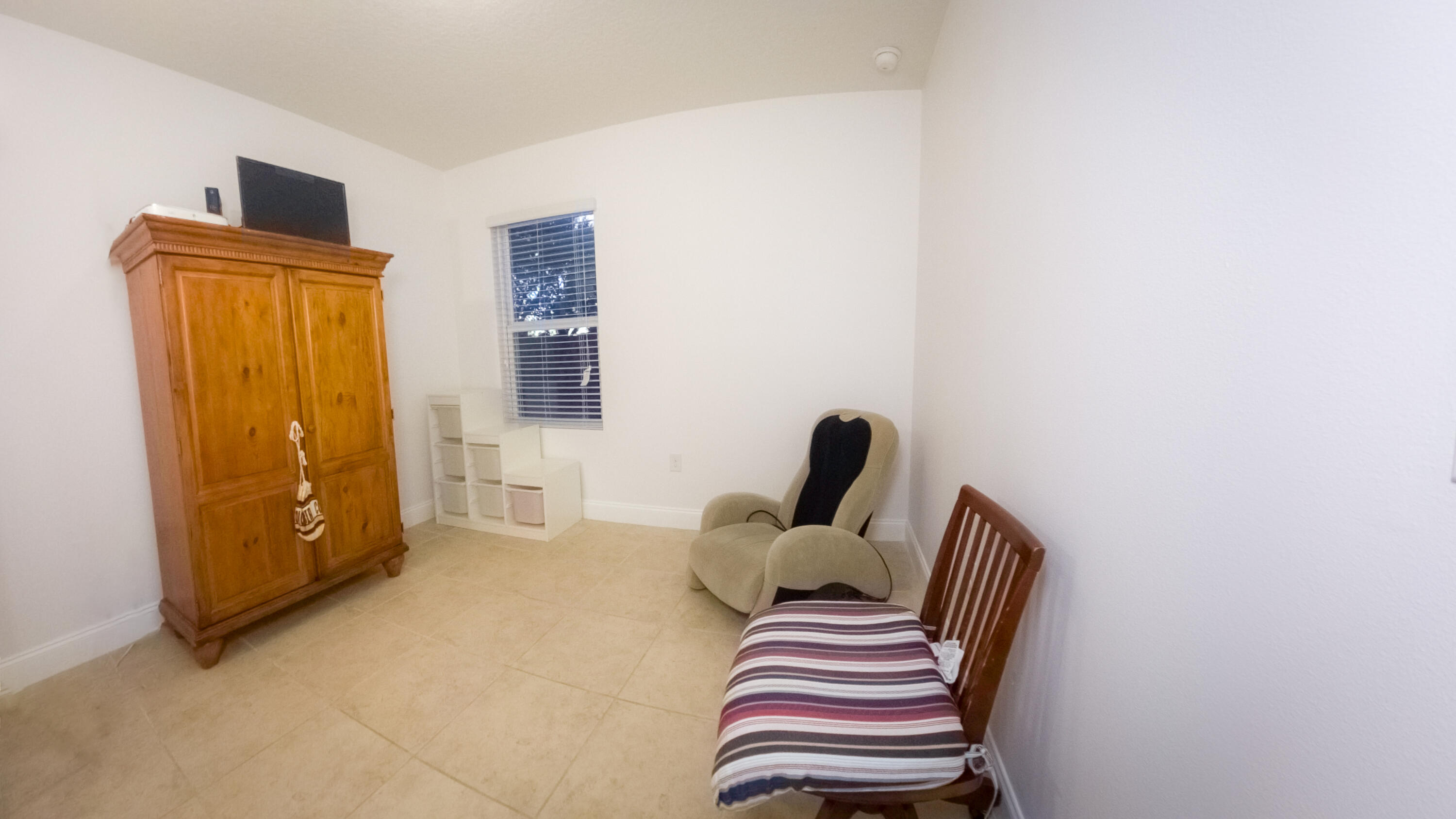 1162 Southwest Coleman Avenue Port St. Lucie, FL 34953 - Photo 8 of 27 a bedroom with furniture and a window