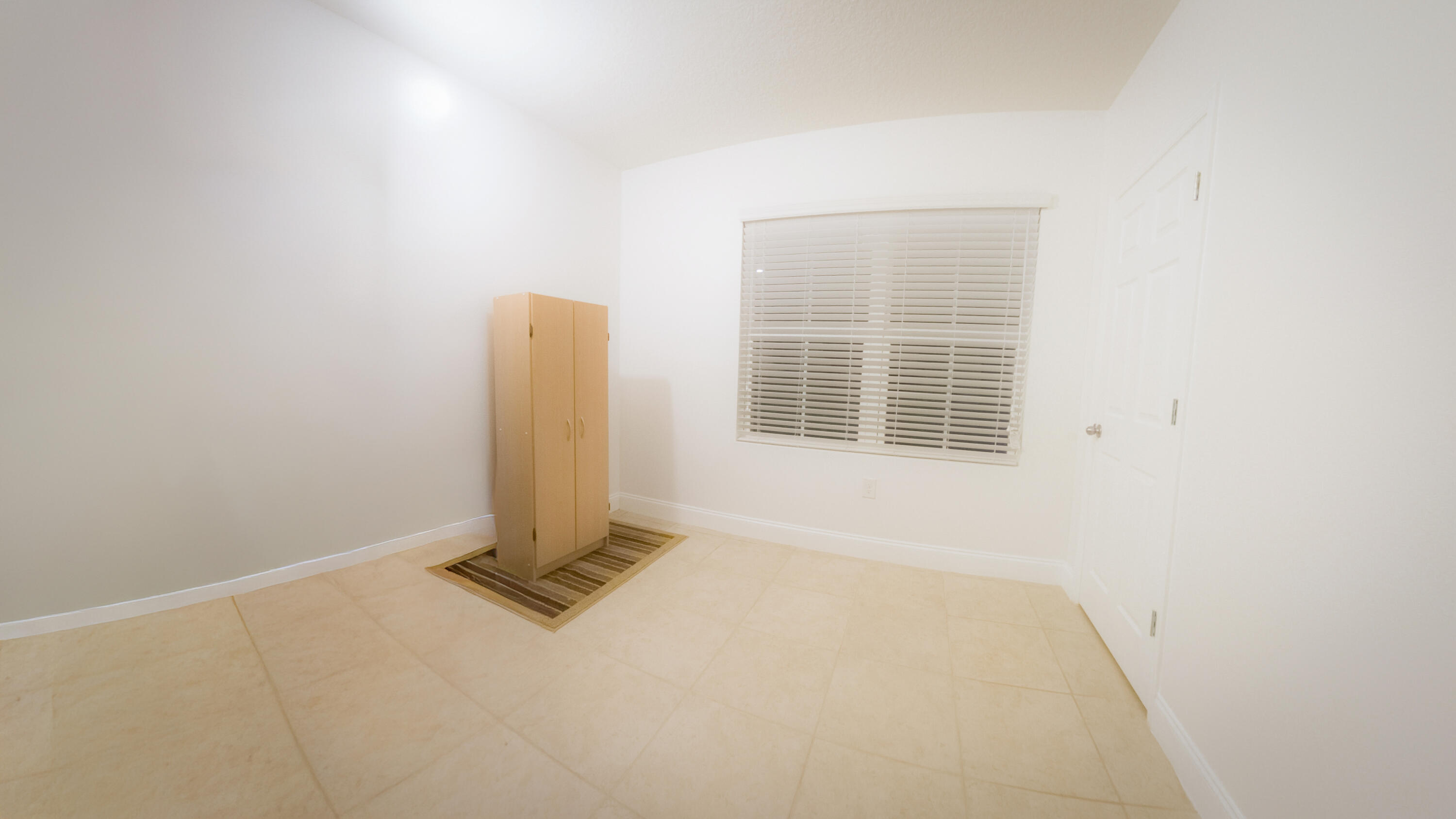 1162 Southwest Coleman Avenue Port St. Lucie, FL 34953 - Photo 9 of 27 an empty room with a window