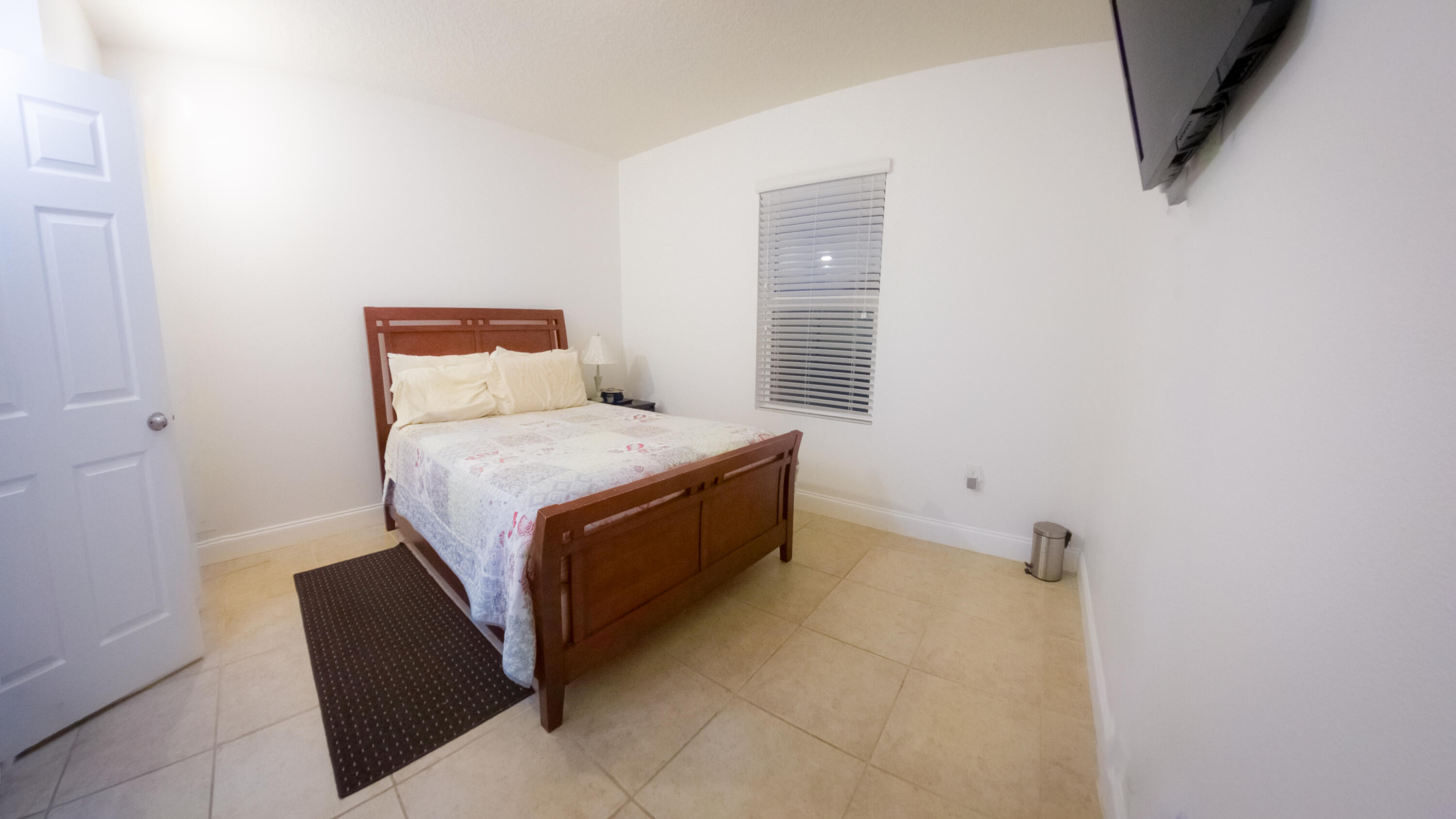 1162 Southwest Coleman Avenue Port St. Lucie, FL 34953 - Photo 10 of 27 a room with a bed and a night stand