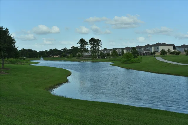 a view of a house with a big yard and sitting area