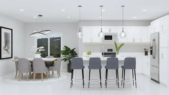 a view of kitchen with dining area refrigerator and wooden floor