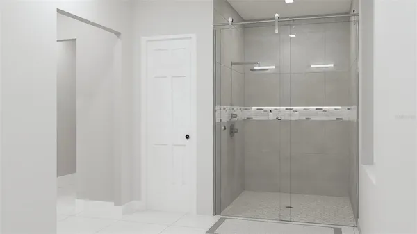a bathroom with a glass shower door