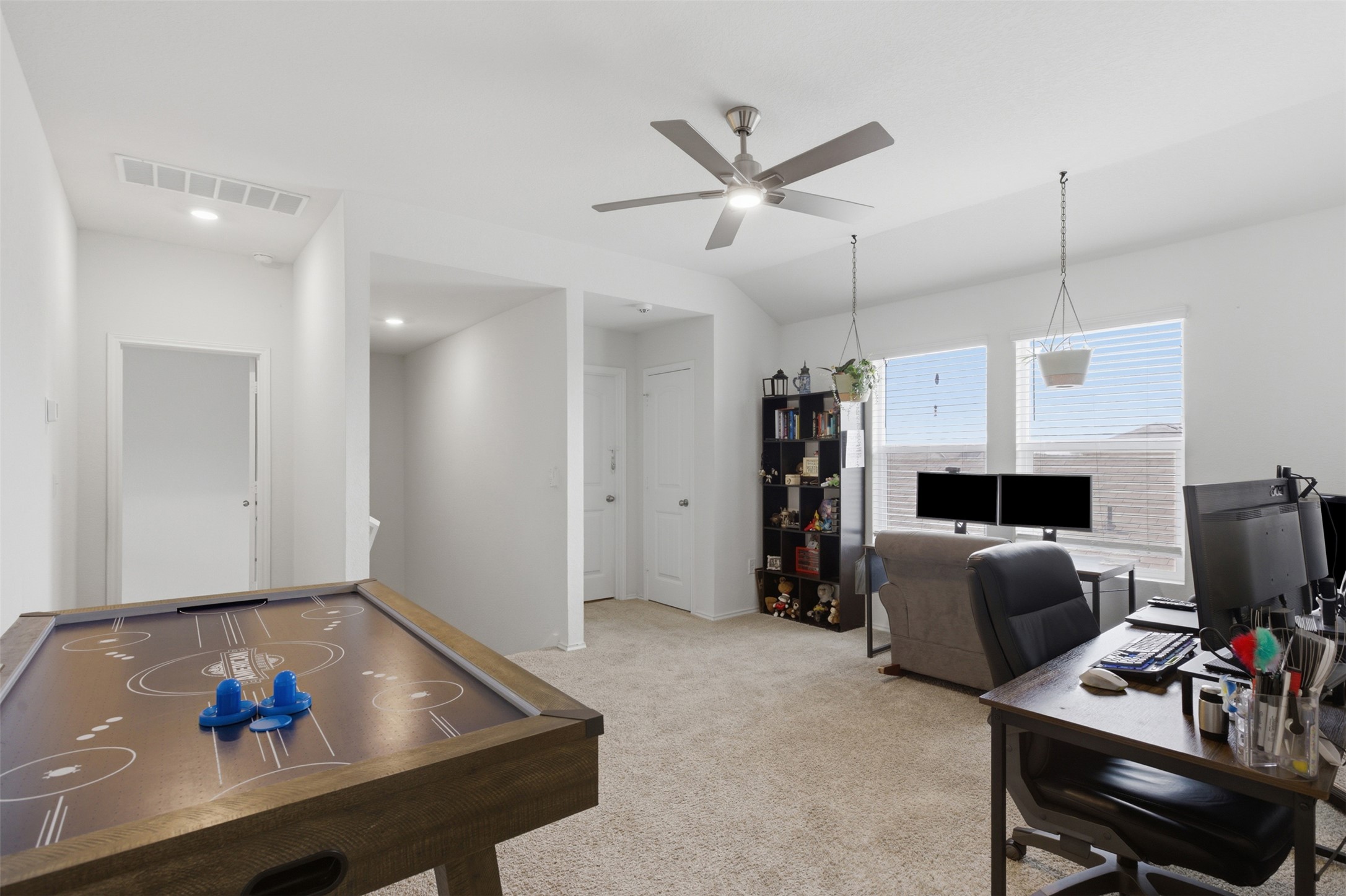 19017 Romano Drive Elgin, TX 78621 - Photo 20 of 33 Spacious bonus room featuring neutral carpeting, a contemporary ceiling fan, and multiple windows with blinds