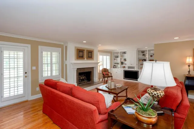 a living room with furniture a fireplace and a table