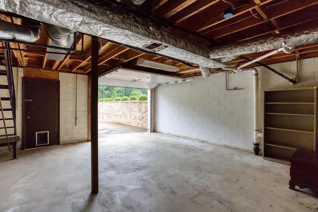 an aerial view of a house with backyard and a patio