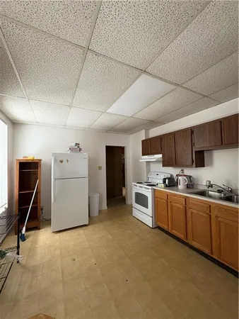 a kitchen with stove top oven and cabinets