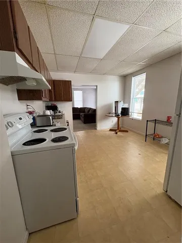 a room with furniture a flat screen tv and a window