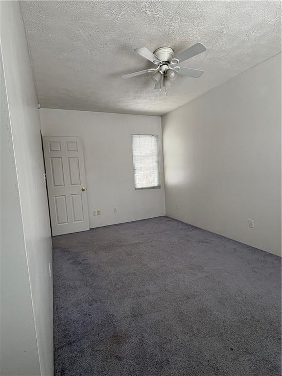 320 Normal Avenue Slippery Rock, PA 16057 - Photo 5 of 7 en empty room with windows and fan