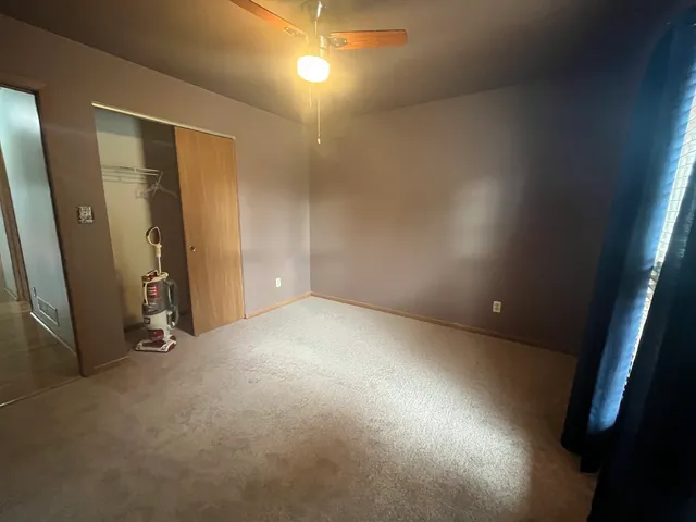 an empty room with closet area