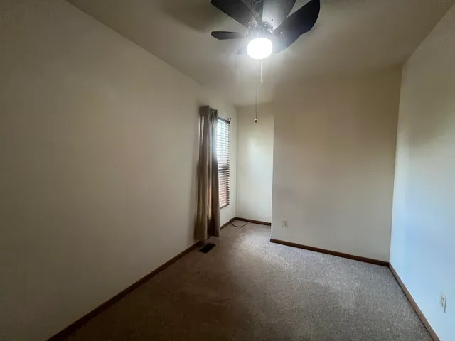 an empty room with a empty space and windows