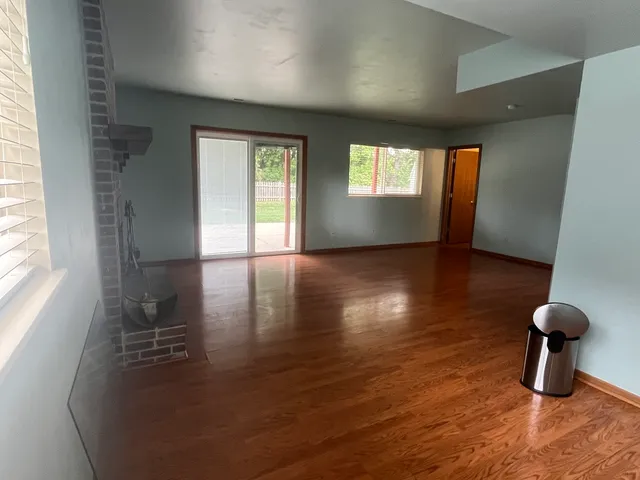 a view of livingroom with furniture wooden floor and windows