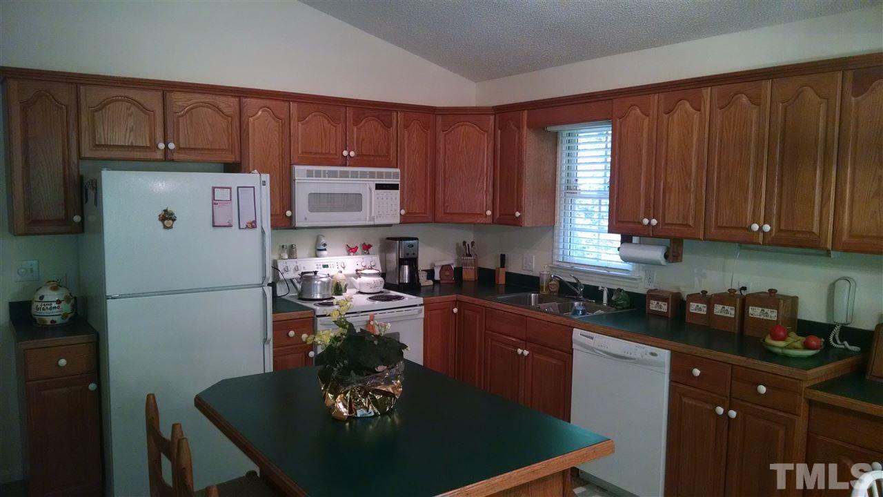210 Nutbush Road Manson, NC 27553 - Photo 4 of 14 a kitchen with a refrigerator a stove a sink and cabinets