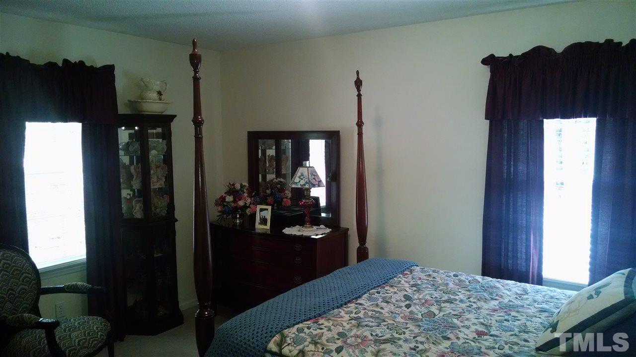 210 Nutbush Road Manson, NC 27553 - Photo 8 of 14 a bedroom with a bed and a dresser