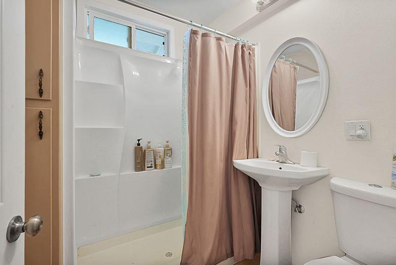 2675 Highway 140 Catheys Valley, CA 95306 - Photo 26 of 53 a bathroom with a sink a mirror and a shower