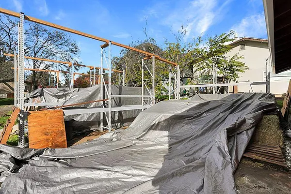 a view of a yard with wooden fence