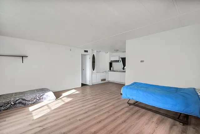 a bedroom with a bed and a window