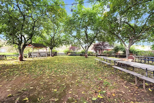 a living room with furniture a flat screen tv and a floor to ceiling window