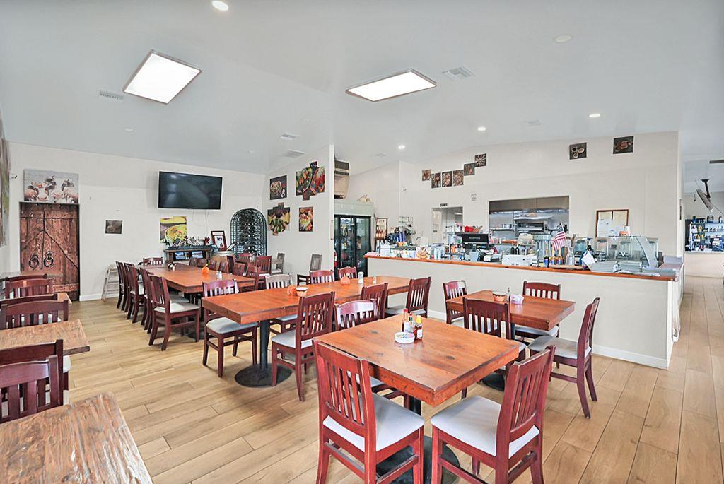 2675 Highway 140 Catheys Valley, CA 95306 - Photo 39 of 53 a dining room with lots of furniture and wooden floor