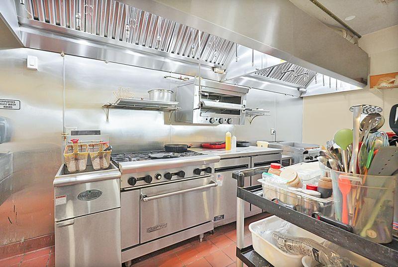 2675 Highway 140 Catheys Valley, CA 95306 - Photo 46 of 53 a kitchen with a stove and wooden floor
