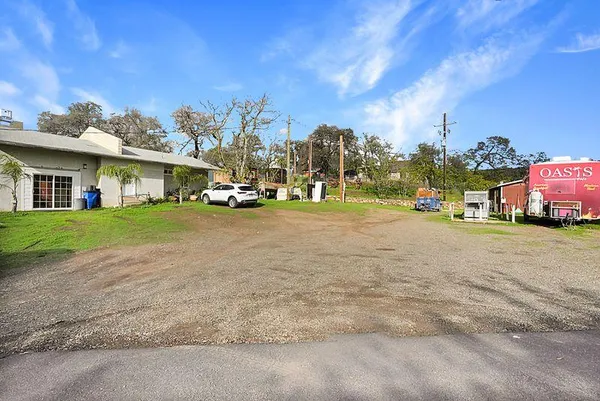 a front view of a house with a garden and parking