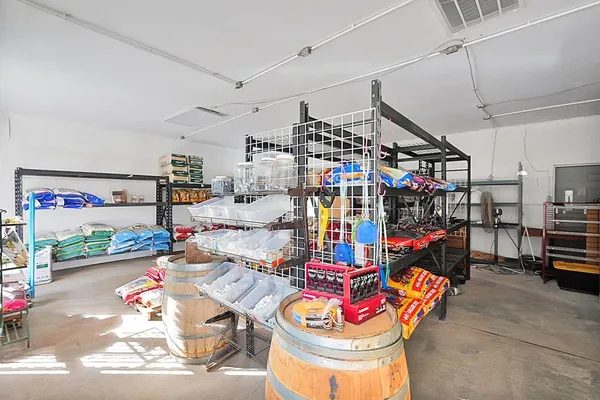 a room with lots of white furniture and a chandelier